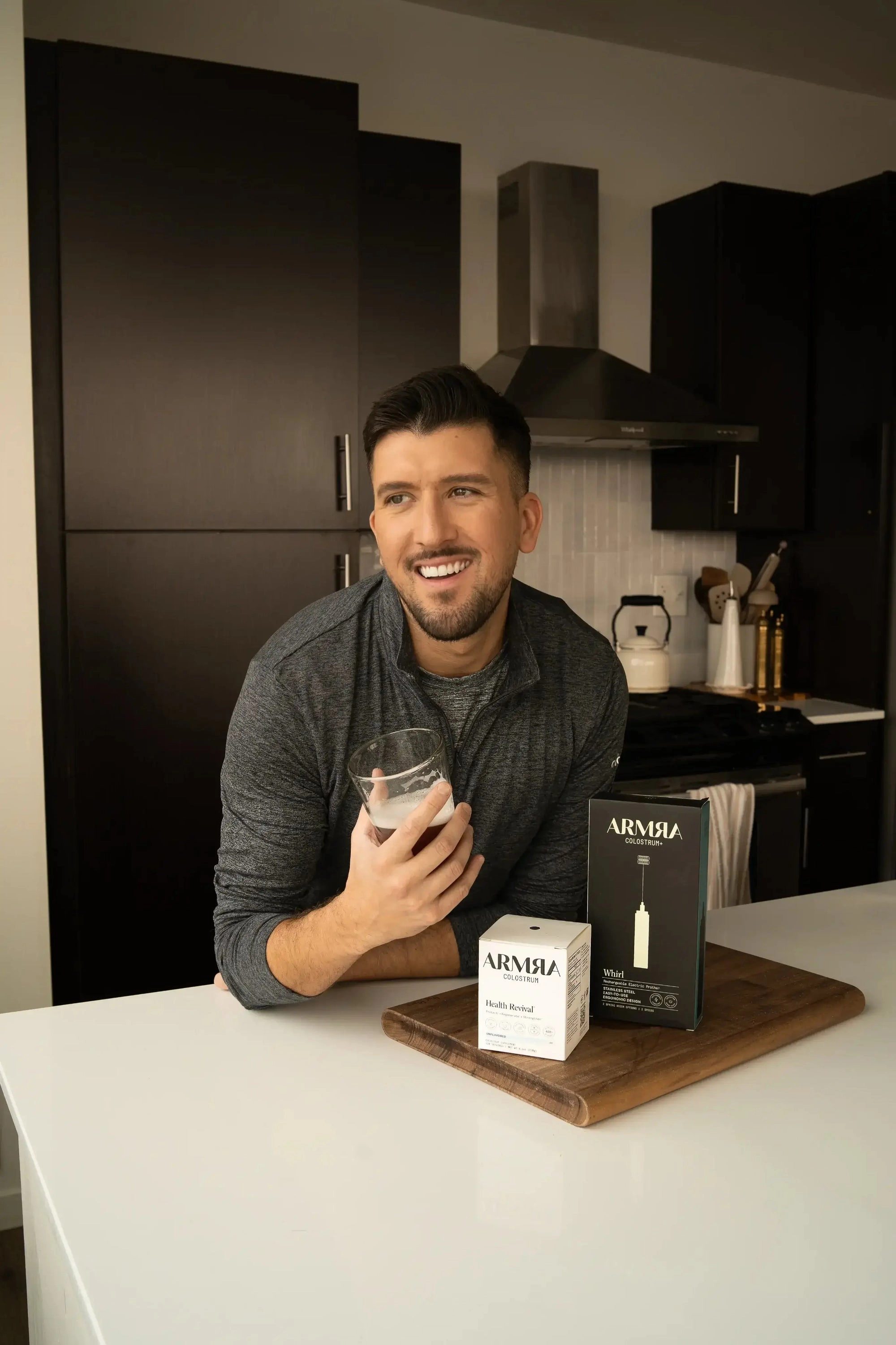 Man at a kitchen counter with ARMRA jars